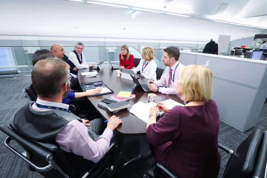 Colleagues discussing business during a meeting