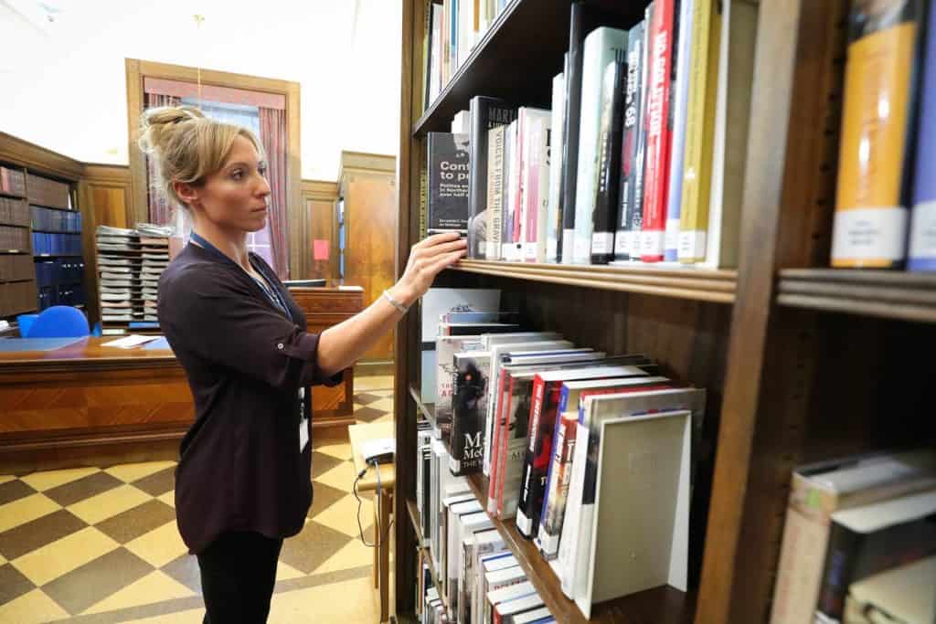 Researcher selecting books in the library