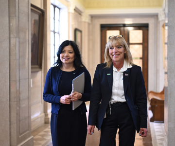 two female employees walking through a corridor